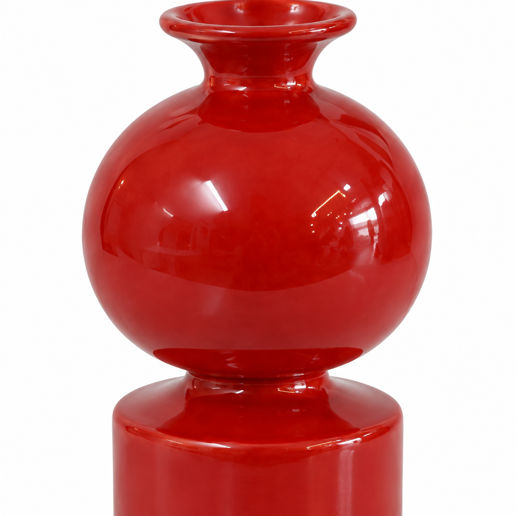Close detail of the rounded body, collar, cylindrical base, and glossy red finish