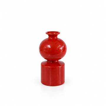 Glossy red sculptural ceramic vase without leaves
