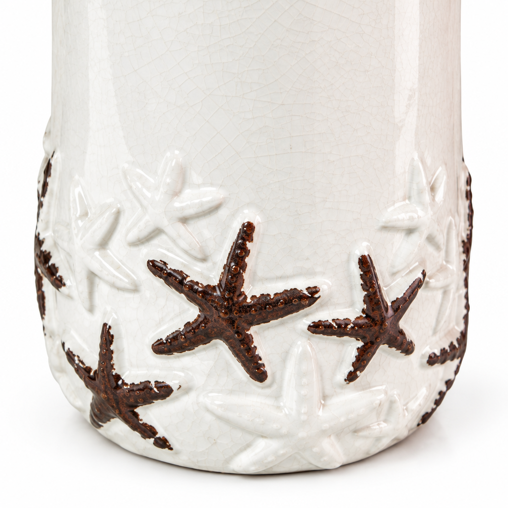 Close-up detail of raised brown starfish, textured white ceramic, and glossy crackle finish