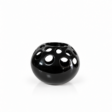 Modern black round cutout ceramic vase shown empty with generous white space