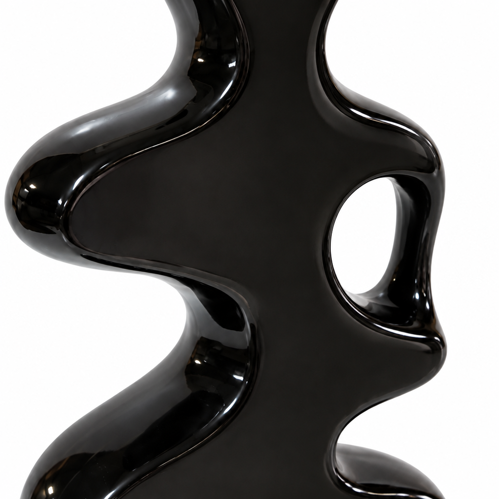 Close-up detail of flowing cutouts, curved edges, and glossy black ceramic finish