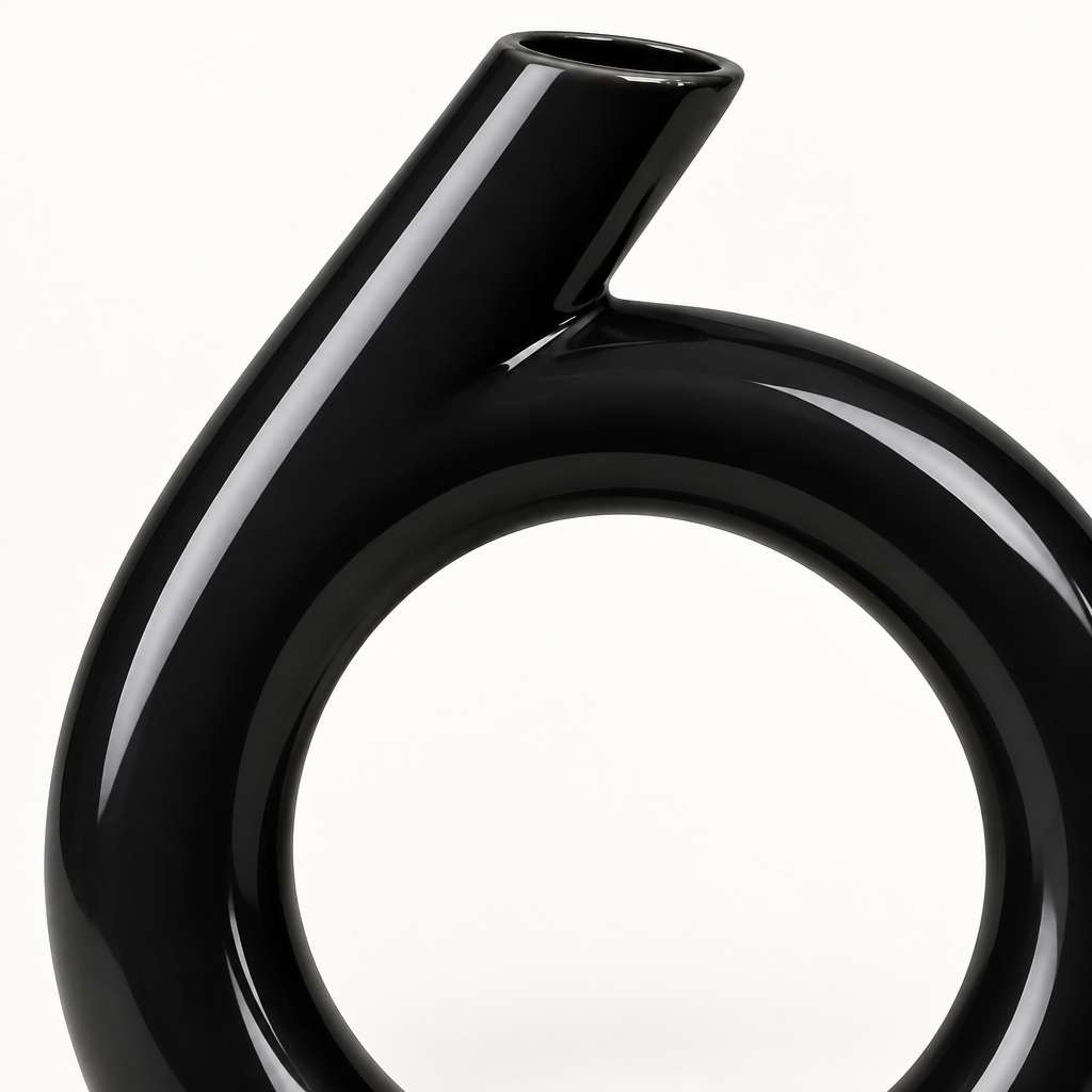 Close-up detail of the glossy black ceramic vase ring and angled neck