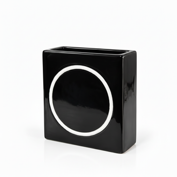Modern black square ceramic vase with white circle accent shown without flowers