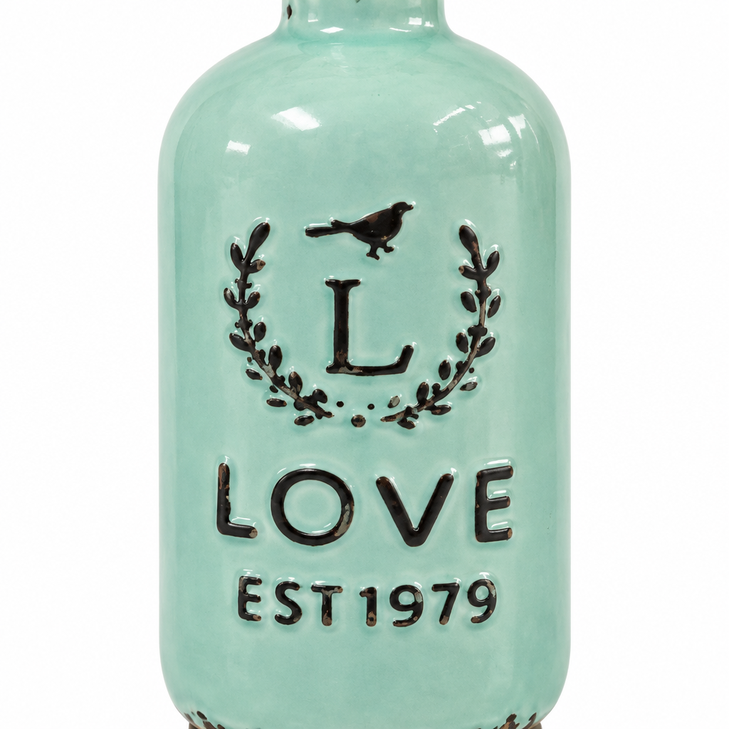 Close-up detail of the bird, laurel, LOVE EST 1979 lettering, and mint ceramic glaze