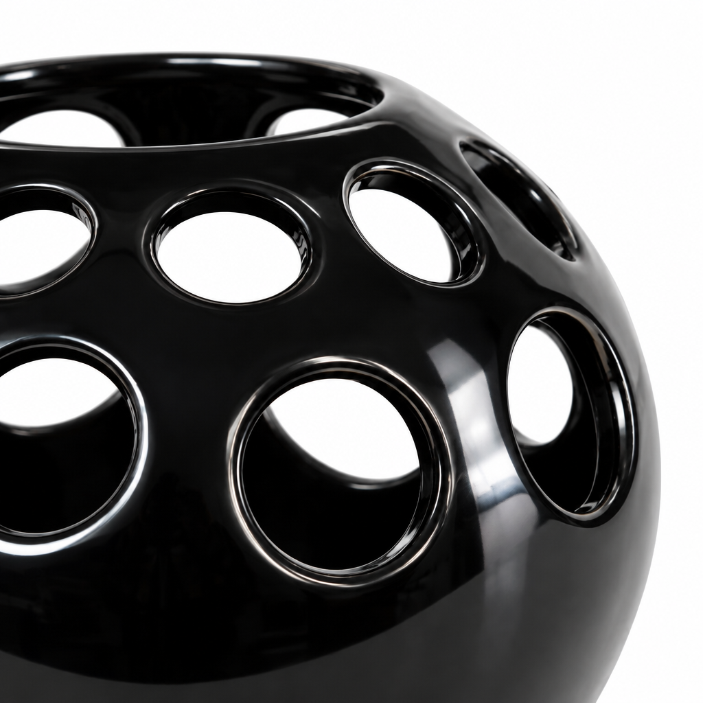 Close-up detail of circular cutouts and glossy black ceramic finish