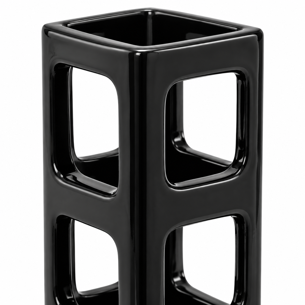 Close-up detail of geometric openings and glossy black ceramic finish