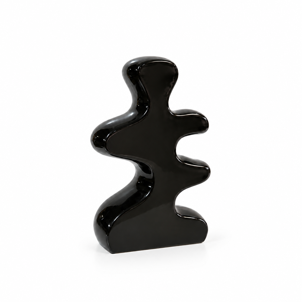 Abstract black cutout ceramic vase shown empty with generous white space