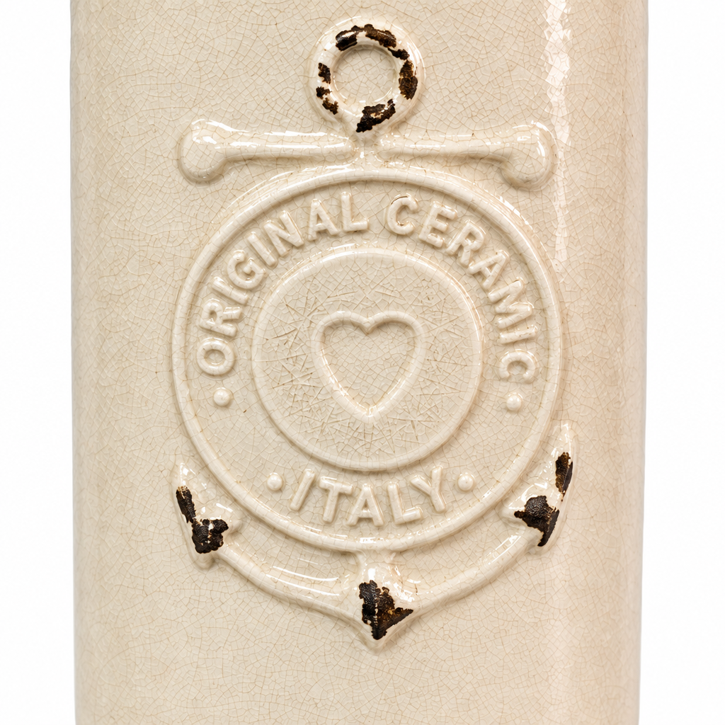 Close-up detail of raised nautical emblem, distressed accents, and ivory crackle glaze