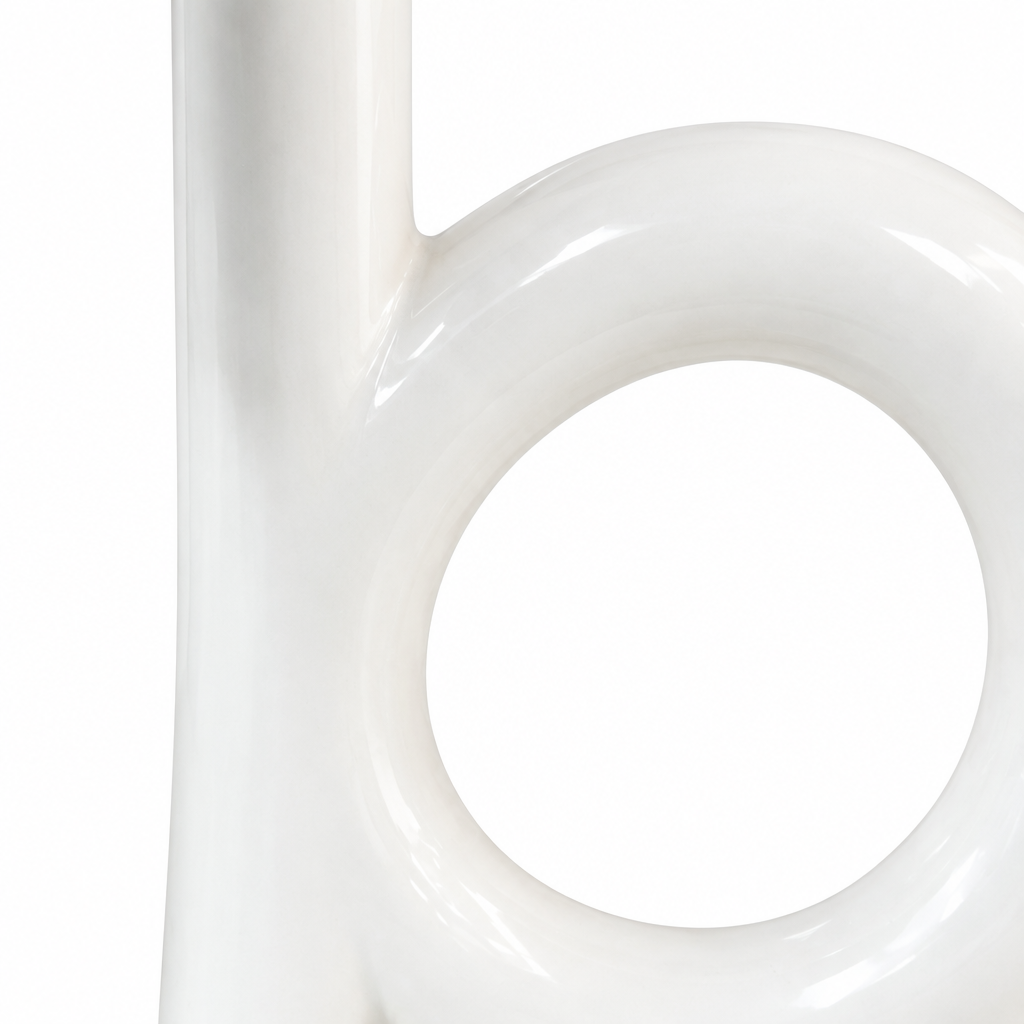 Close-up detail of the white ceramic loop shape and glossy finish