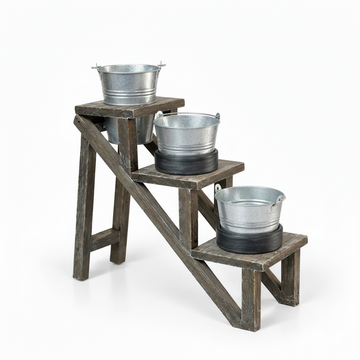 Rustic three-tier plant stand shown smaller with all galvanized planters empty