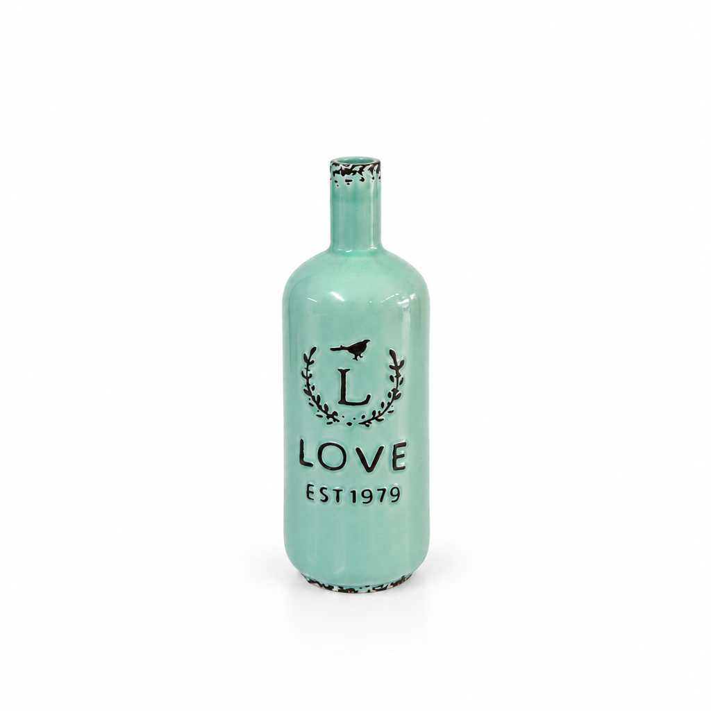 Vintage mint green LOVE EST 1979 ceramic bottle vase shown empty on white