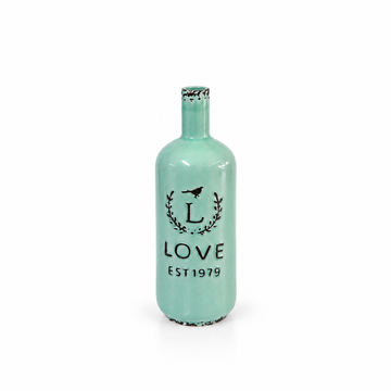 Vintage mint green LOVE EST 1979 ceramic bottle vase shown empty on white