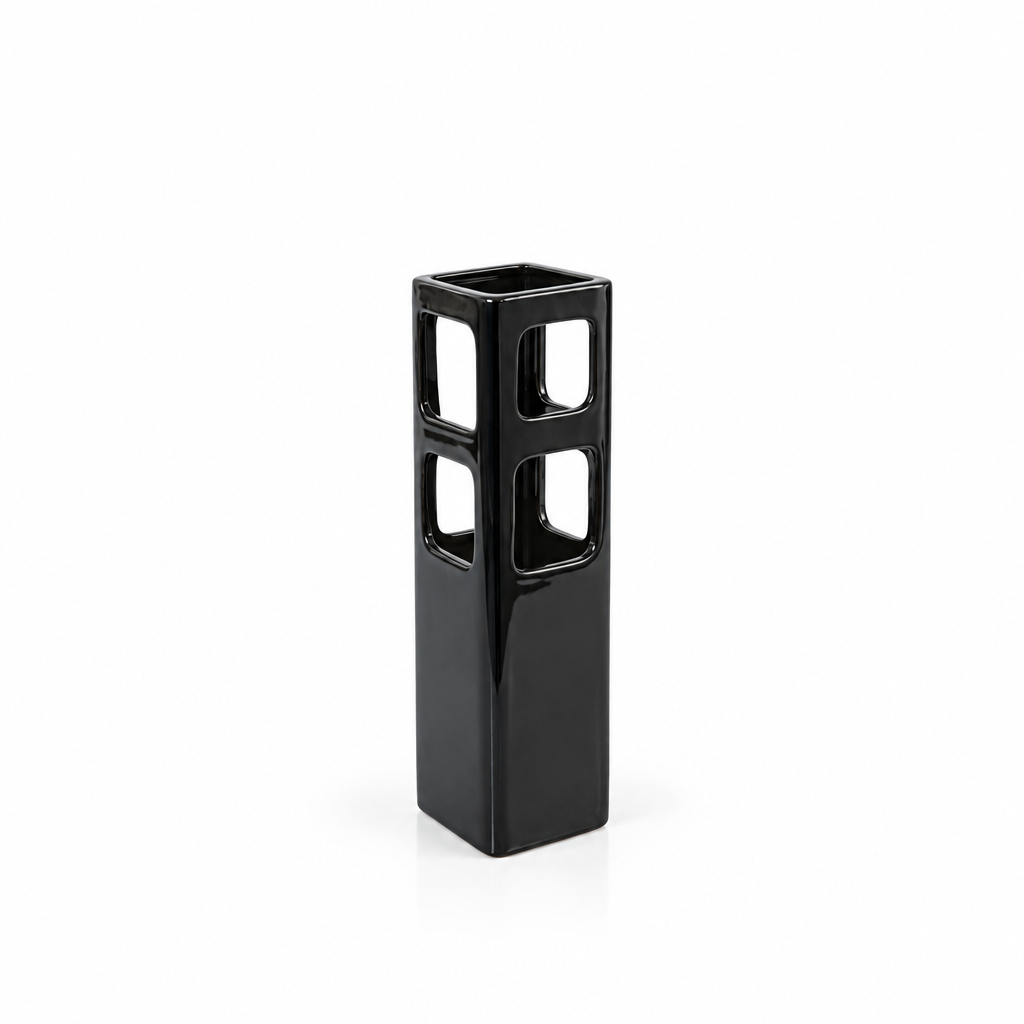 Tall black geometric cutout ceramic vase shown empty with generous white space