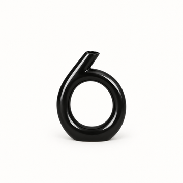 Glossy black circular sculptural ceramic vase shown alone on a clean studio background